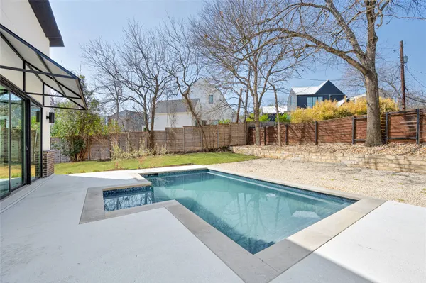 a view of a backyard with a large tree