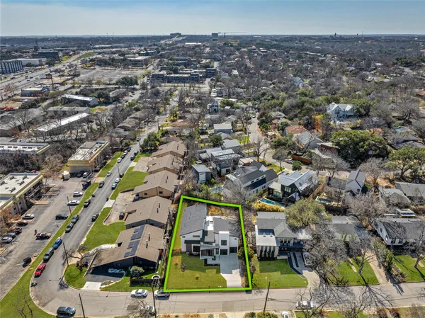 an aerial view of residential houses with yard