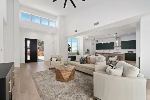 a living room with furniture and kitchen view