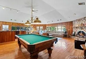 a room with lots of furniture and wooden floor