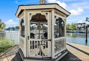 a view of a small house with a wooden deck
