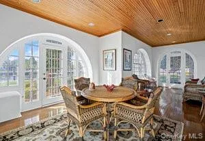 a dining room with furniture a rug and wooden floor