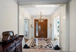 a bedroom with furniture and a chandelier