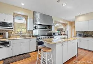 a kitchen with stainless steel appliances granite countertop a sink and cabinets