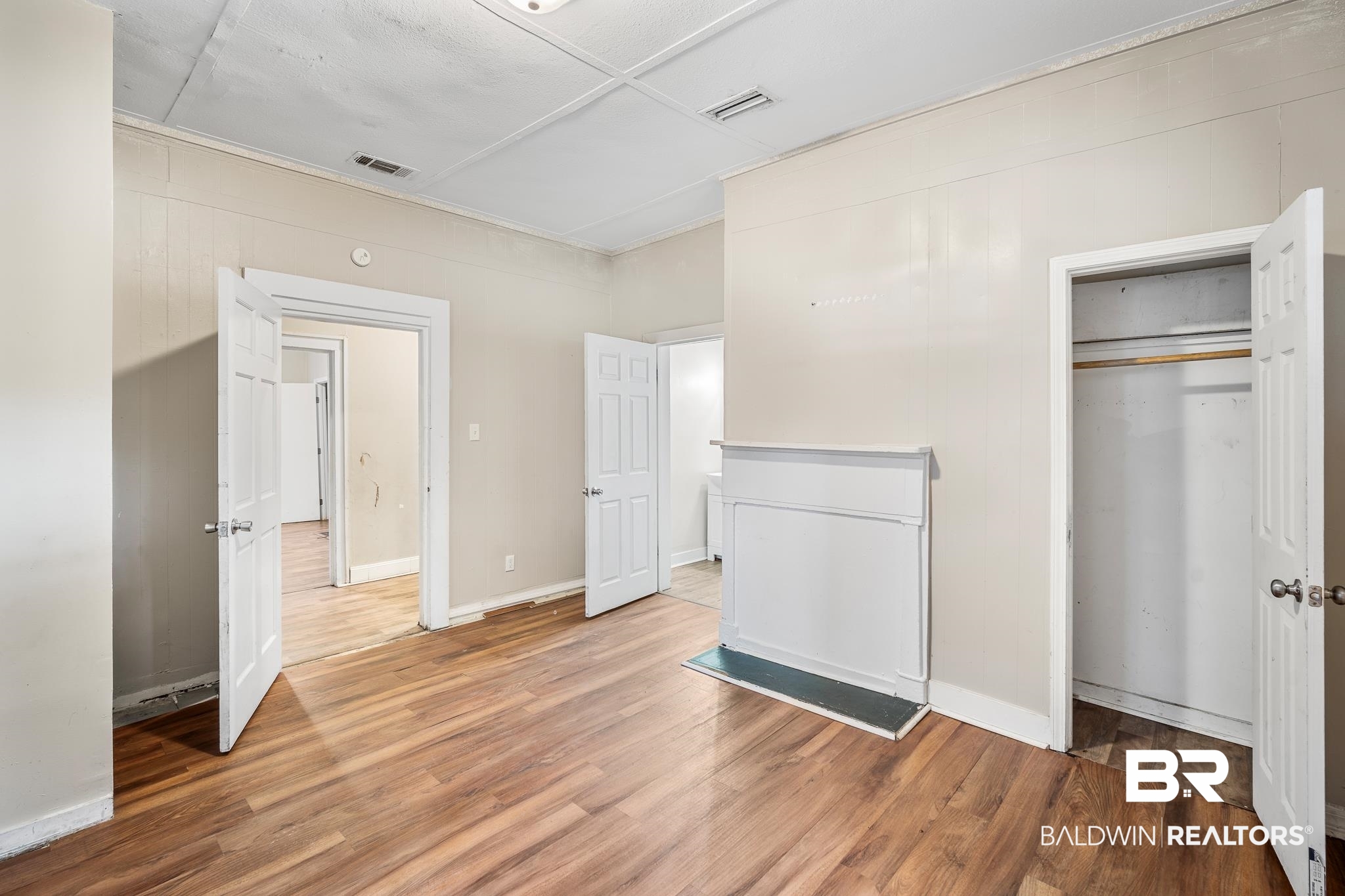401 Gaston Street Mobile, AL 36603 - Photo 8 of 17 Unfurnished bedroom featuring wood-type flooring and a closet