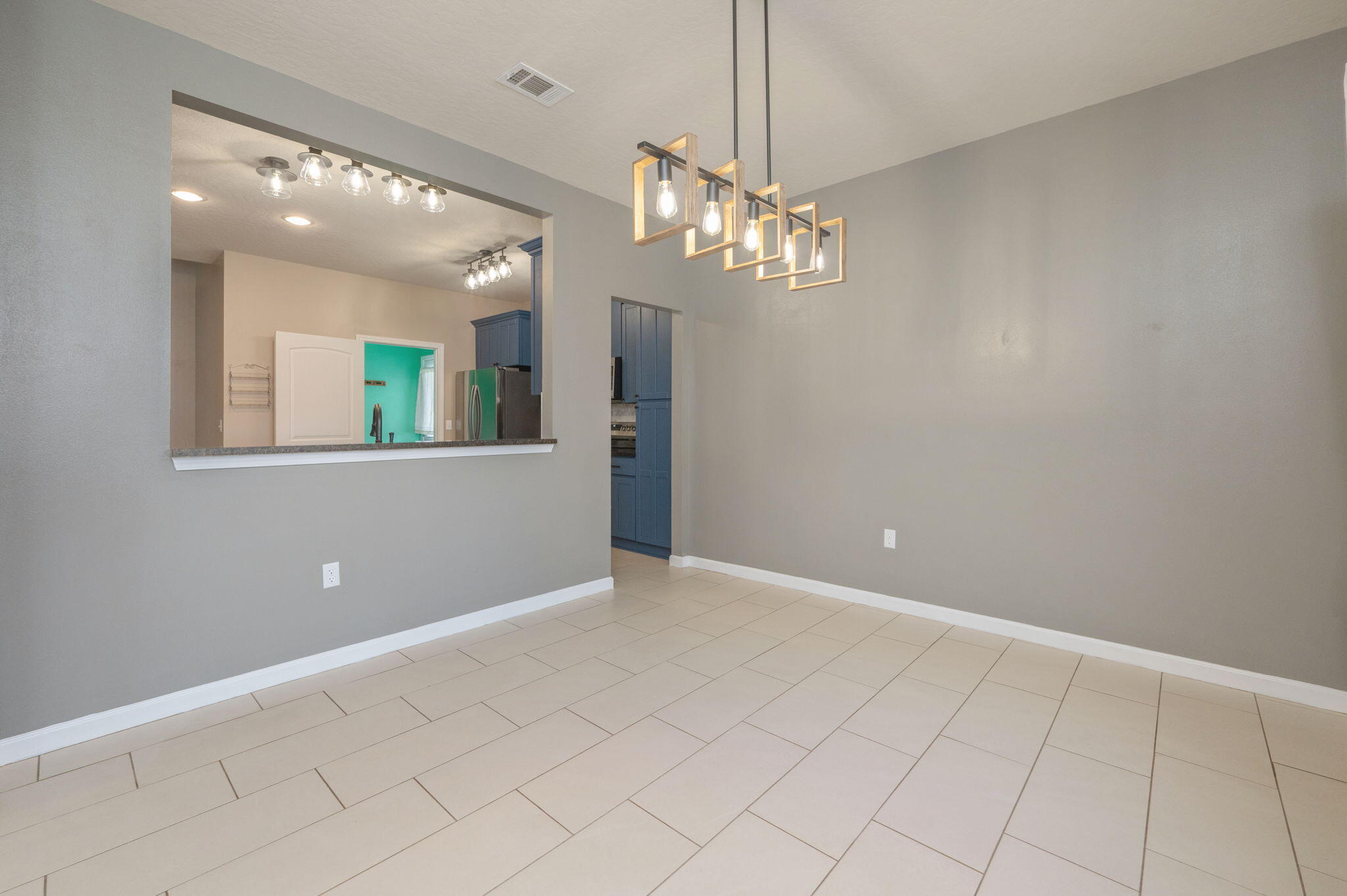 5275 Moore Loop Crestview, FL 32536 - Photo 13 of 32 a view of a livingroom with a chandelier fan and kitchen view