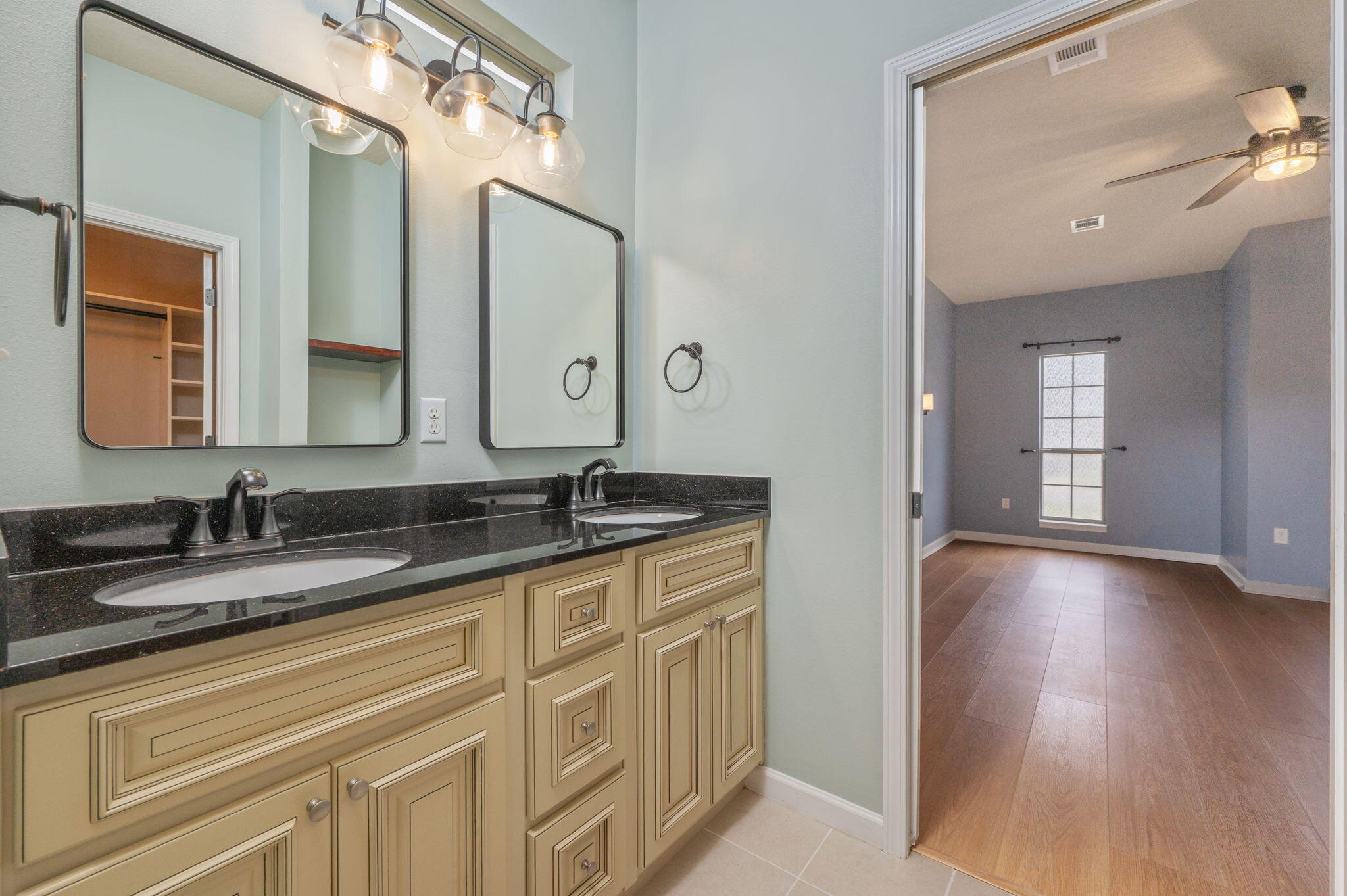 5275 Moore Loop Crestview, FL 32536 - Photo 15 of 32 a bathroom with a granite countertop double vanity sink and a mirror