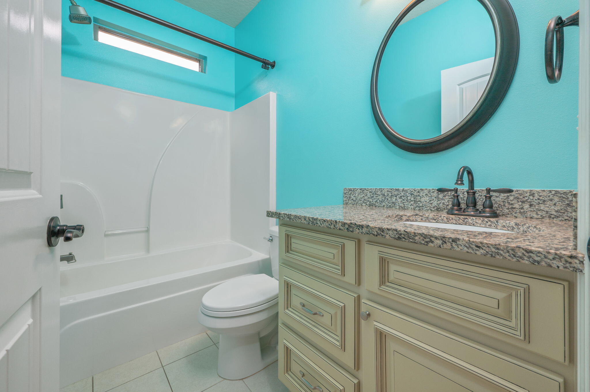 5275 Moore Loop Crestview, FL 32536 - Photo 21 of 32 a bathroom with a granite countertop toilet a sink and a mirror