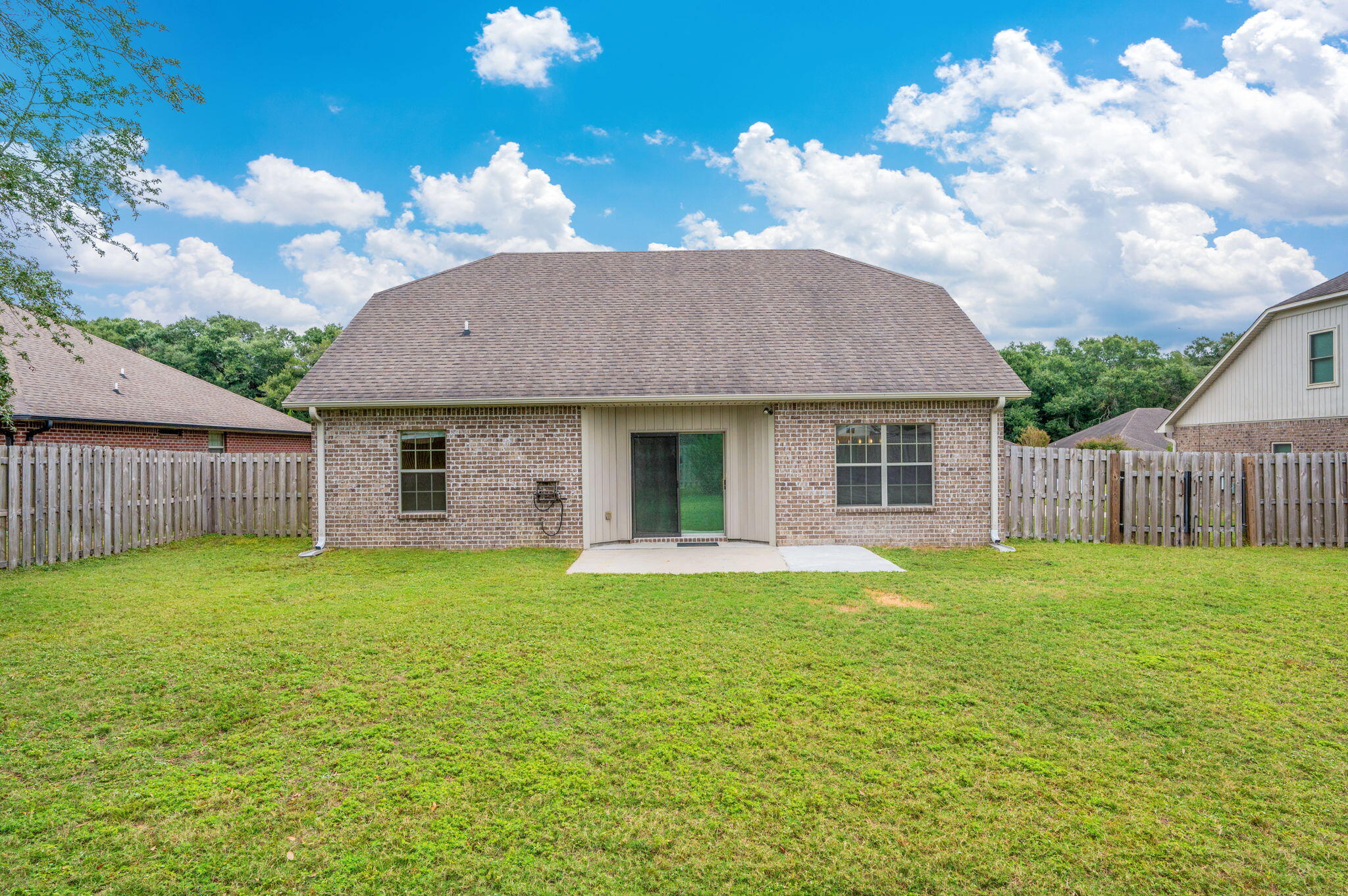 5275 Moore Loop Crestview, FL 32536 - Photo 29 of 32 a front view of a house with a garden and yard