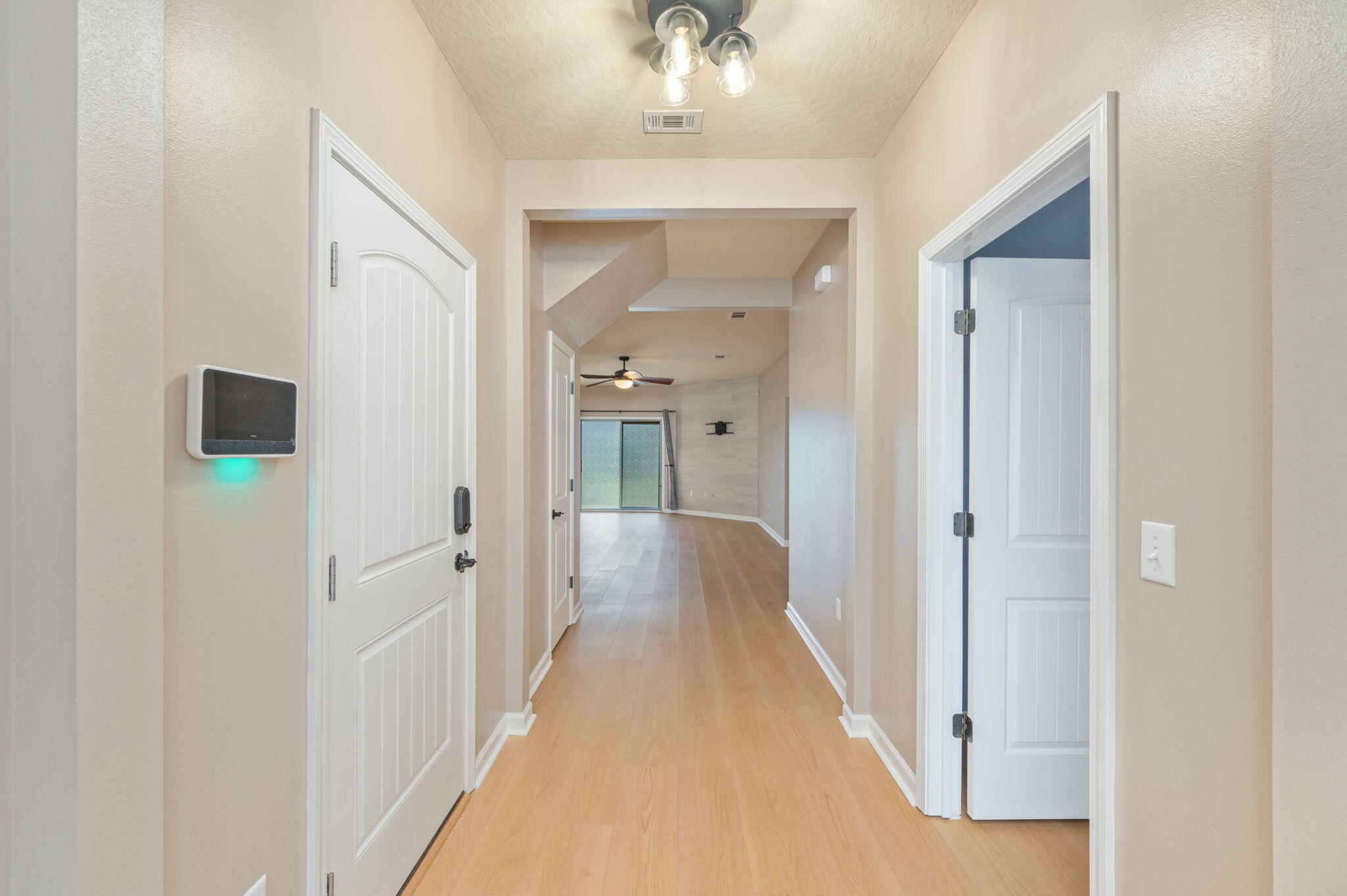 5275 Moore Loop Crestview, FL 32536 - Photo 8 of 32 a view of a hallway with a wooden floor
