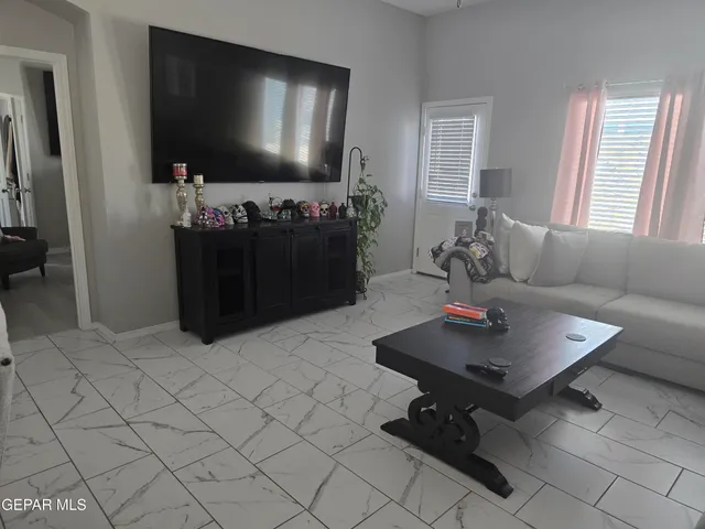 a living room with furniture and a flat screen tv