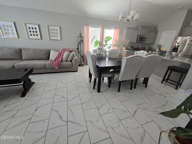 a living room with furniture and a chandelier