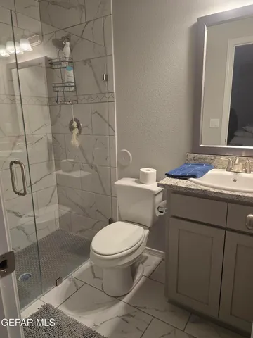 a bedroom with a bed and a mirror