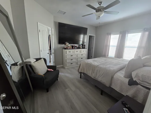 a bed sitting in a bedroom next to a window