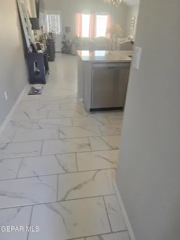 a living room with a couch and a stove next to a window