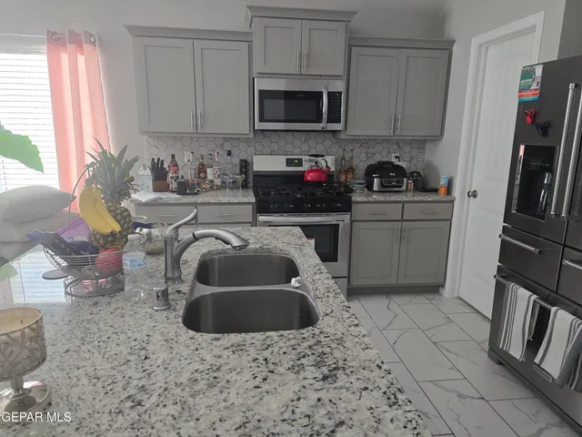a kitchen with a sink a stove and cabinets