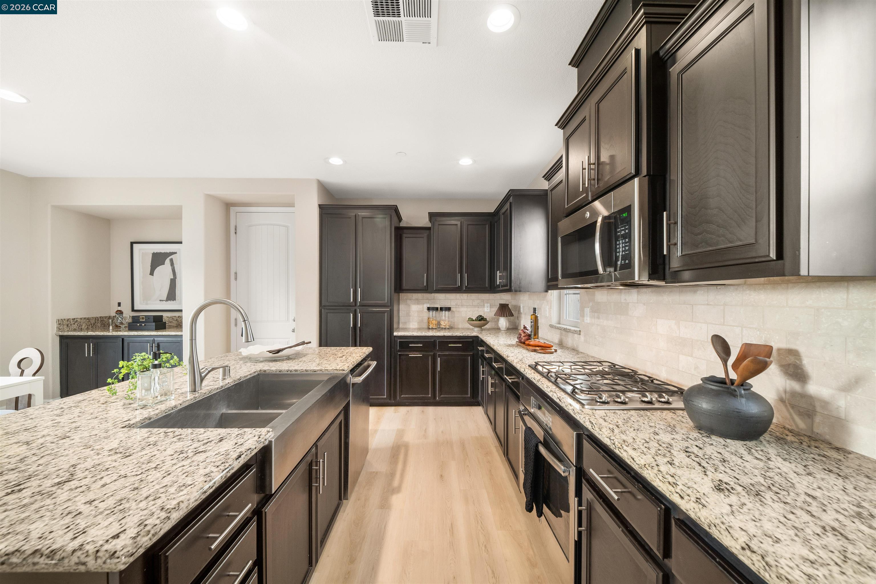 2026 Poinsettia Street San Ramon, CA 94582 - Photo 11 of 26 a kitchen with granite countertop a sink stove and cabinets