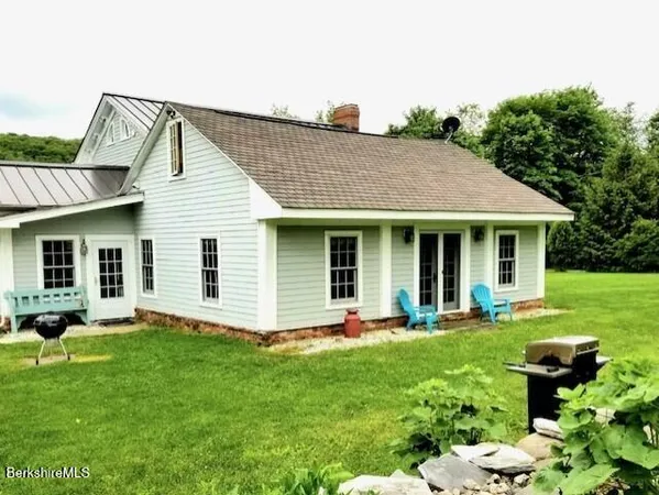 a front view of house with a garden and patio