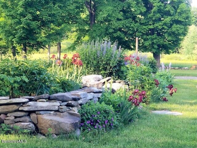 257 North Main Street Hancock, MA 01237 - Photo 11 of 13 a front view of a house with a yard and fountain