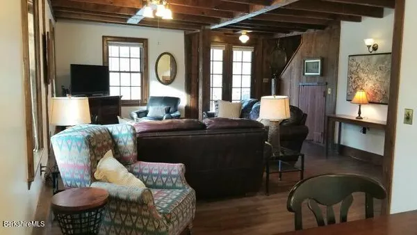 a living room with furniture fireplace and flat screen tv