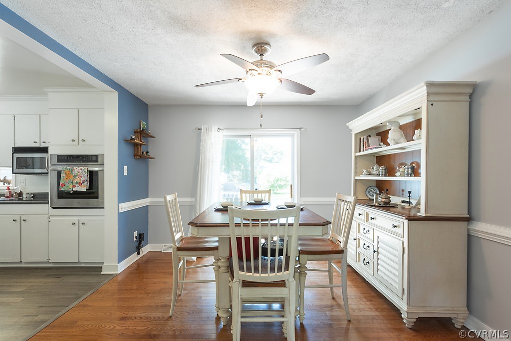 3825 Frankmont Road Richmond, VA 23234 - Photo 12 of 47 a very nice looking kitchen with granite countertop a stove top oven a sink a dining table and chairs