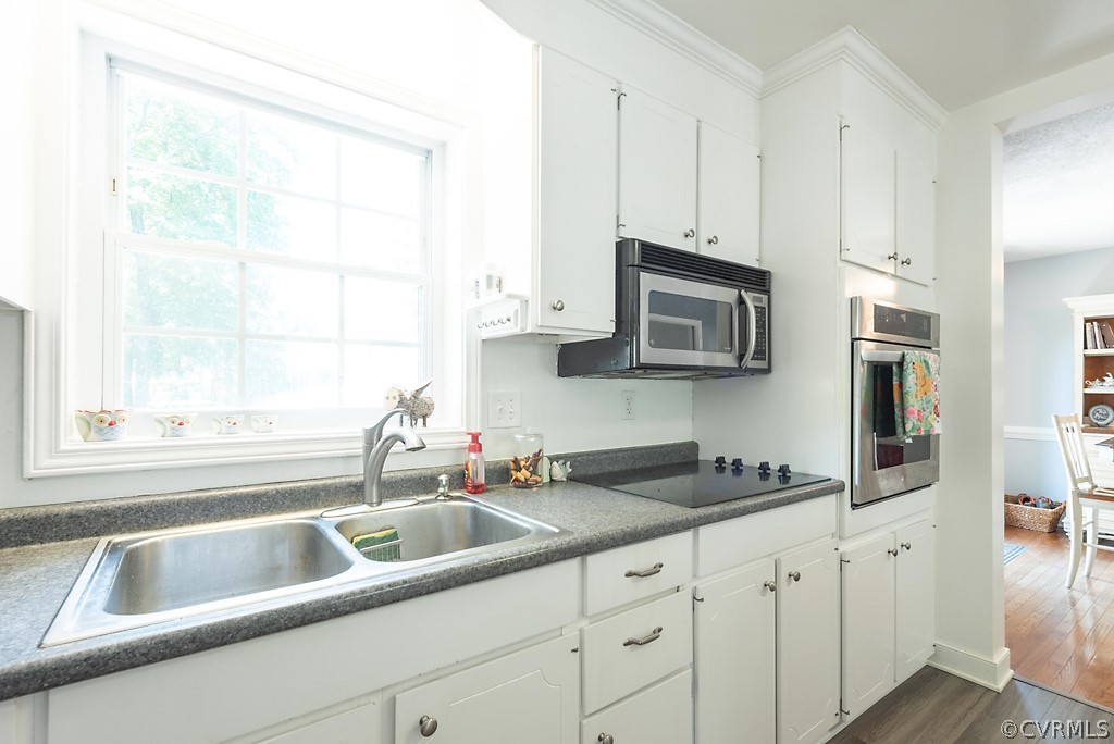 3825 Frankmont Road Richmond, VA 23234 - Photo 19 of 47 a kitchen with granite countertop a sink a window and stainless steel appliances