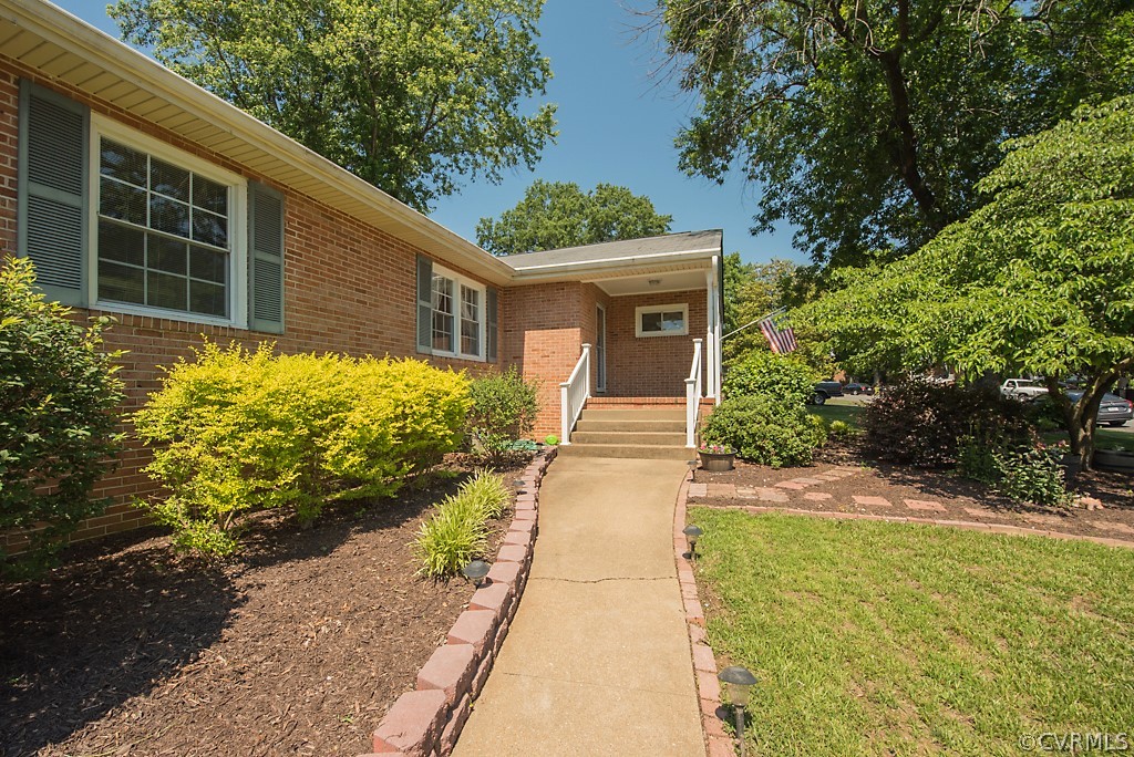 3825 Frankmont Road Richmond, VA 23234 - Photo 2 of 47 a front view of a house with a yard and garage