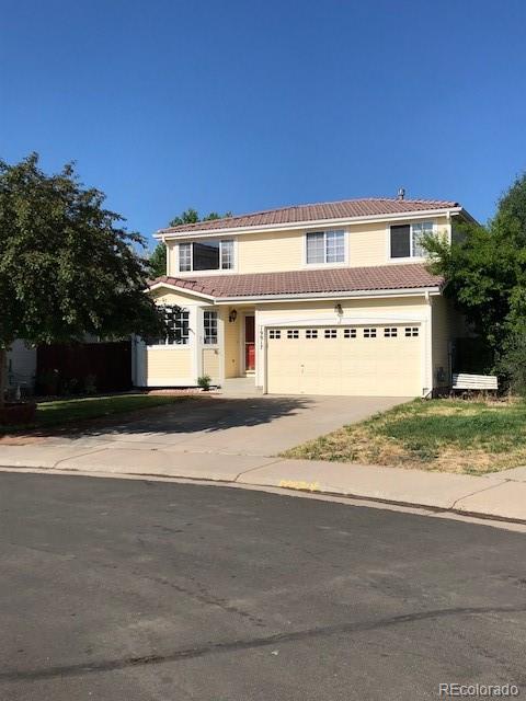 19917 Mitchell Circle Denver, CO 80249 - Photo 2 of 13 a front view of a house with a yard