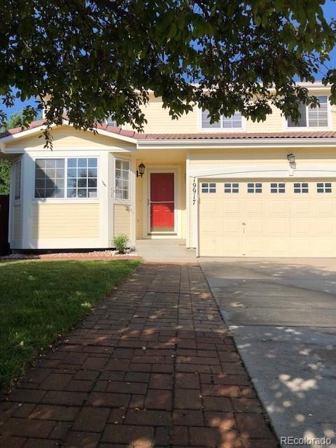 19917 Mitchell Circle Denver, CO 80249 - Photo 3 of 13 a front view of a house with garden