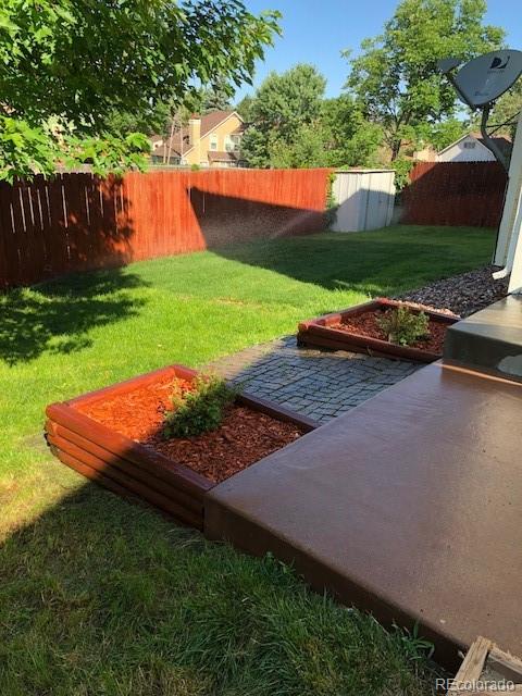19917 Mitchell Circle Denver, CO 80249 - Photo 4 of 13 a view of a backyard with large trees