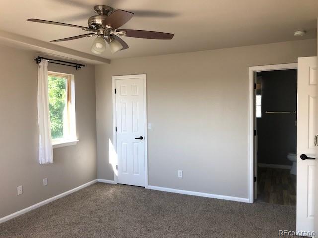 19917 Mitchell Circle Denver, CO 80249 - Photo 8 of 13 an empty room with a window and a fan