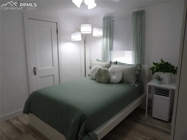 a bedroom with a bed and a potted plant