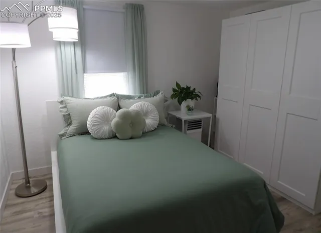 a bedroom with a bed and a table