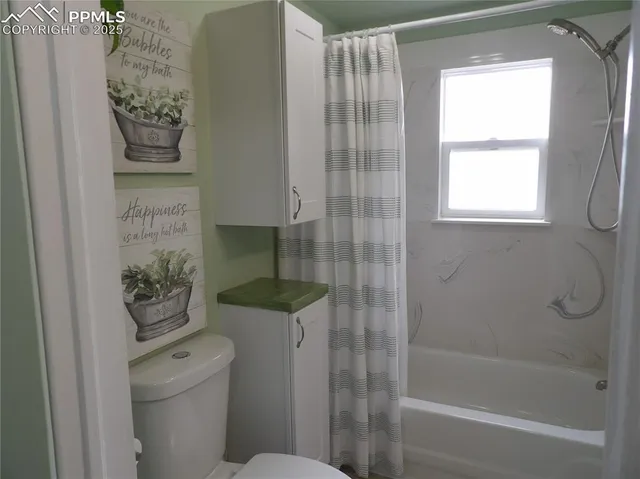 a bathroom with a toilet and shower