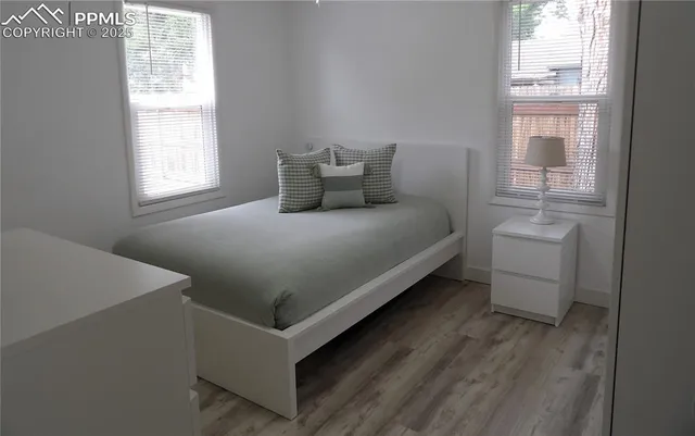 a bed sitting in a bedroom next to a window