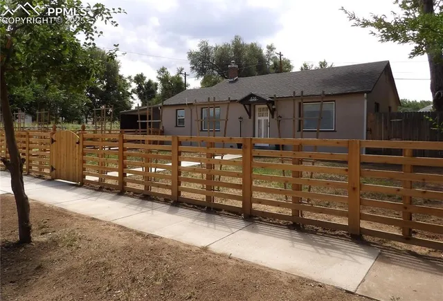 front view of a house with a large tree