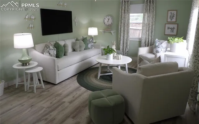 a living room with furniture and a wooden floor