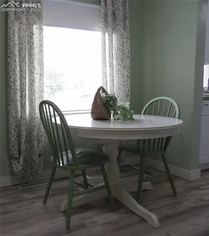 a view of a dining room with furniture and window