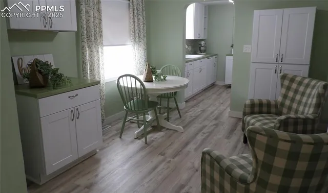 a view of a dining room with furniture and wooden floor