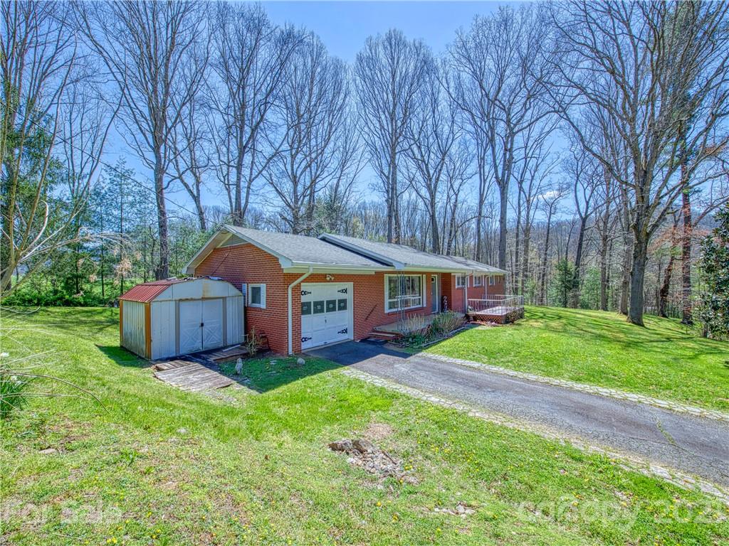 720 Iron Duff Road Waynesville, NC 28785 - Photo 2 of 37 a front view of a house with yard and green space