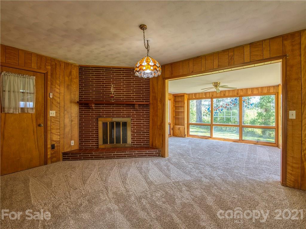 720 Iron Duff Road Waynesville, NC 28785 - Photo 13 of 37 a view of an empty room with window and fire place