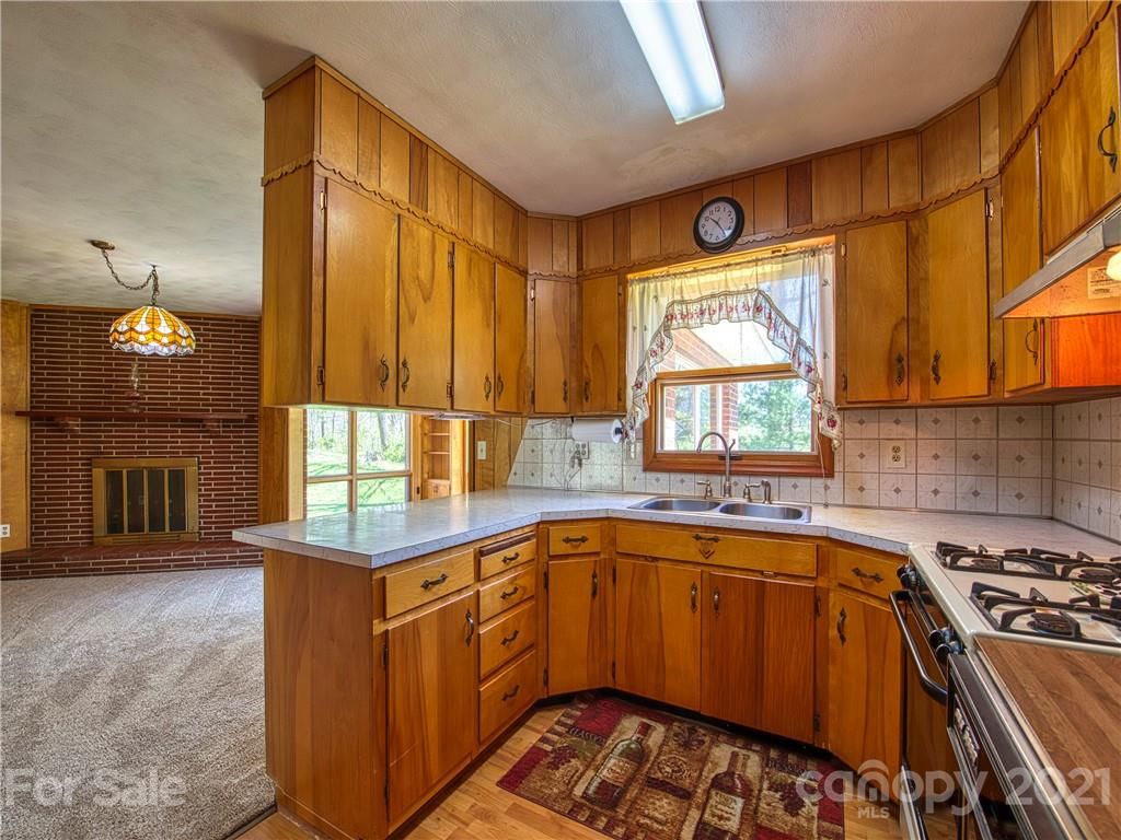 720 Iron Duff Road Waynesville, NC 28785 - Photo 18 of 37 a kitchen that has a sink and a stove in it