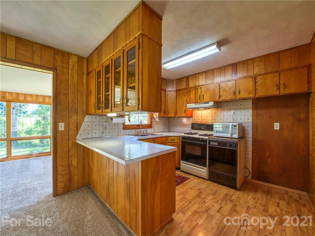 720 Iron Duff Road Waynesville, NC 28785 - Photo 19 of 37 a kitchen with stainless steel appliances granite countertop a sink and a stove
