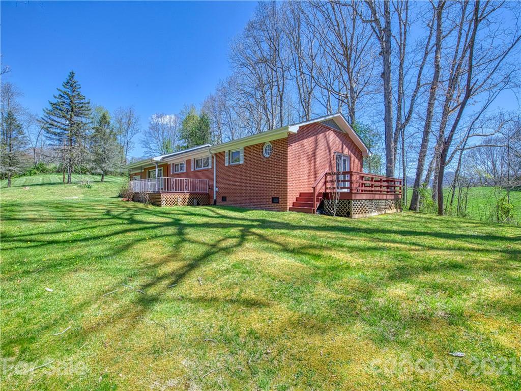 720 Iron Duff Road Waynesville, NC 28785 - Photo 4 of 37 a front view of house with yard and trees in the background