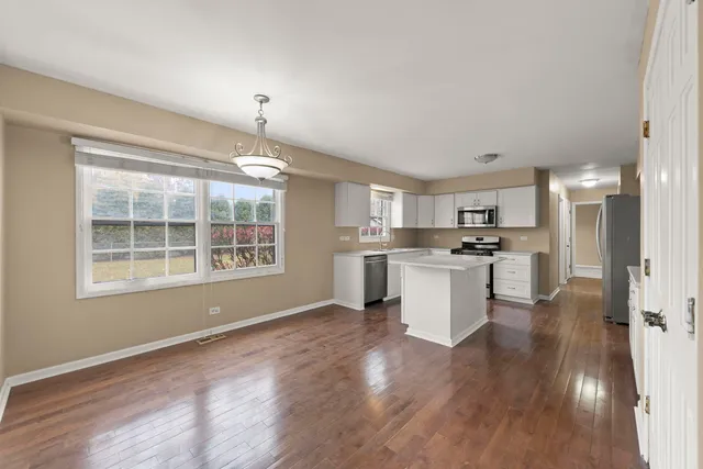 a view of kitchen with wooden floor and windows