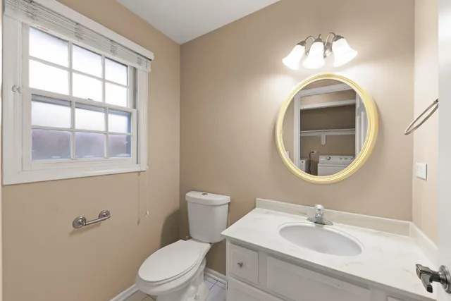 a bathroom with a sink a toilet and a mirror