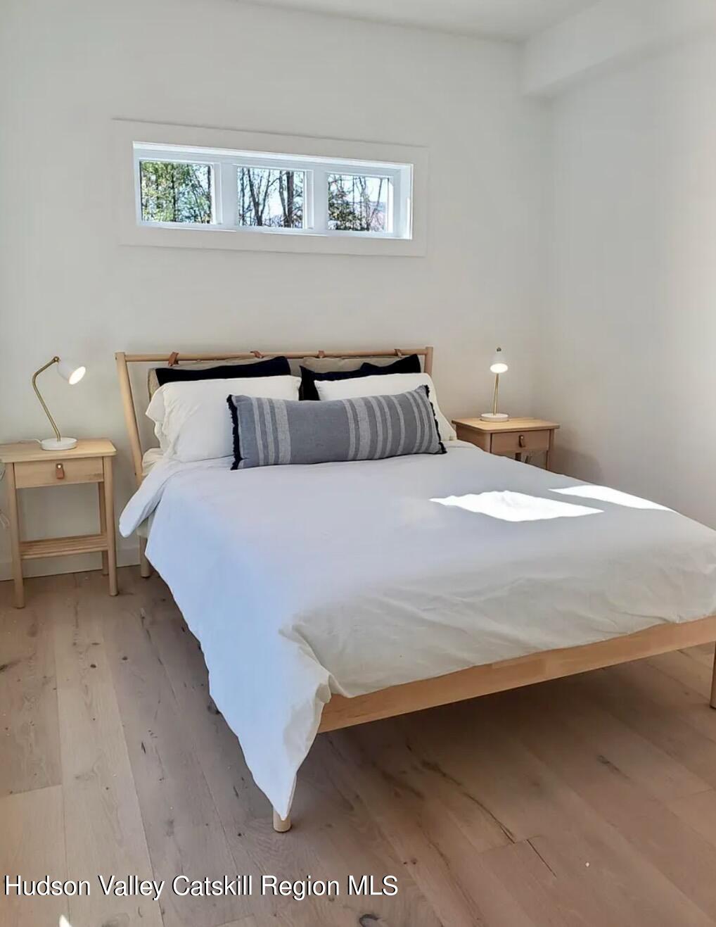 382 Beaverkill Road Olivebridge, NY 12461 - Photo 19 of 40 a bedroom with a bed and a night stand