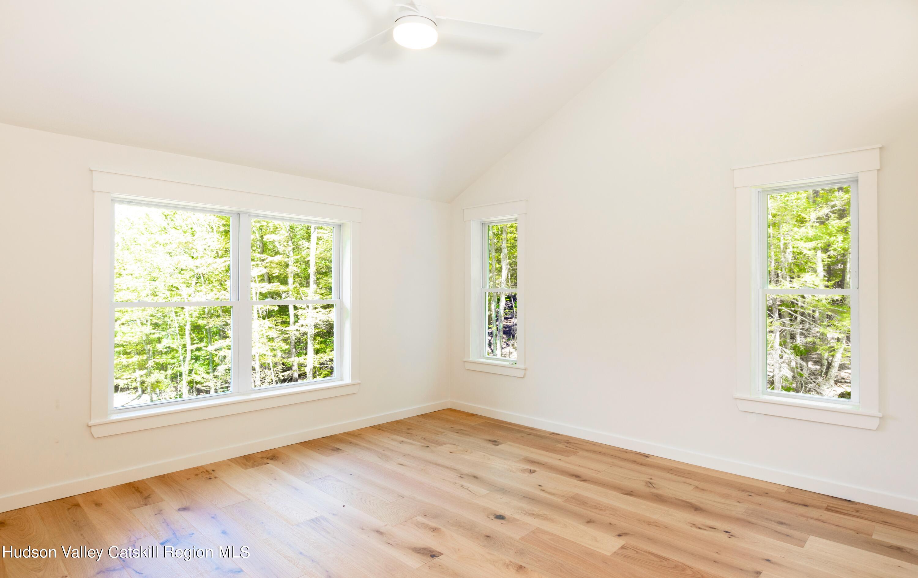 382 Beaverkill Road Olivebridge, NY 12461 - Photo 26 of 40 an empty room with wooden floor and windows