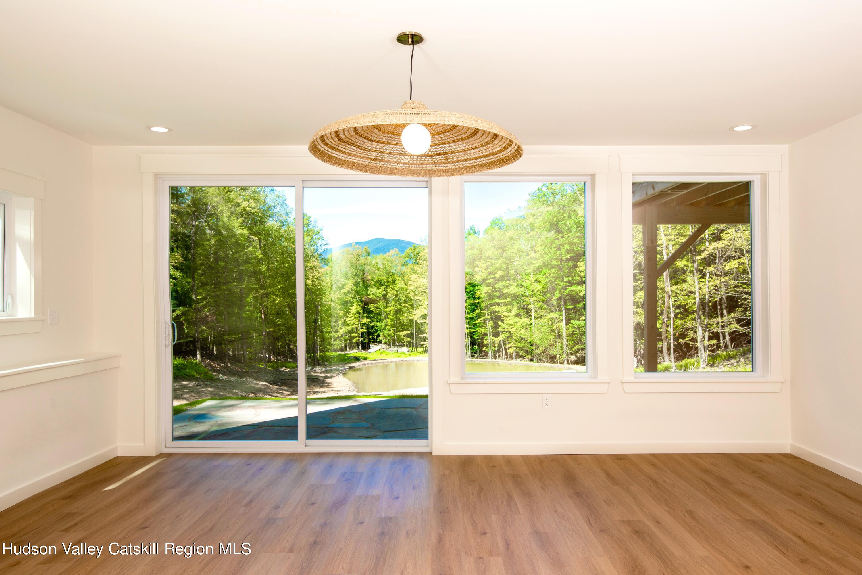 382 Beaverkill Road Olivebridge, NY 12461 - Photo 32 of 40 a view of an empty room with wooden floor and a window
