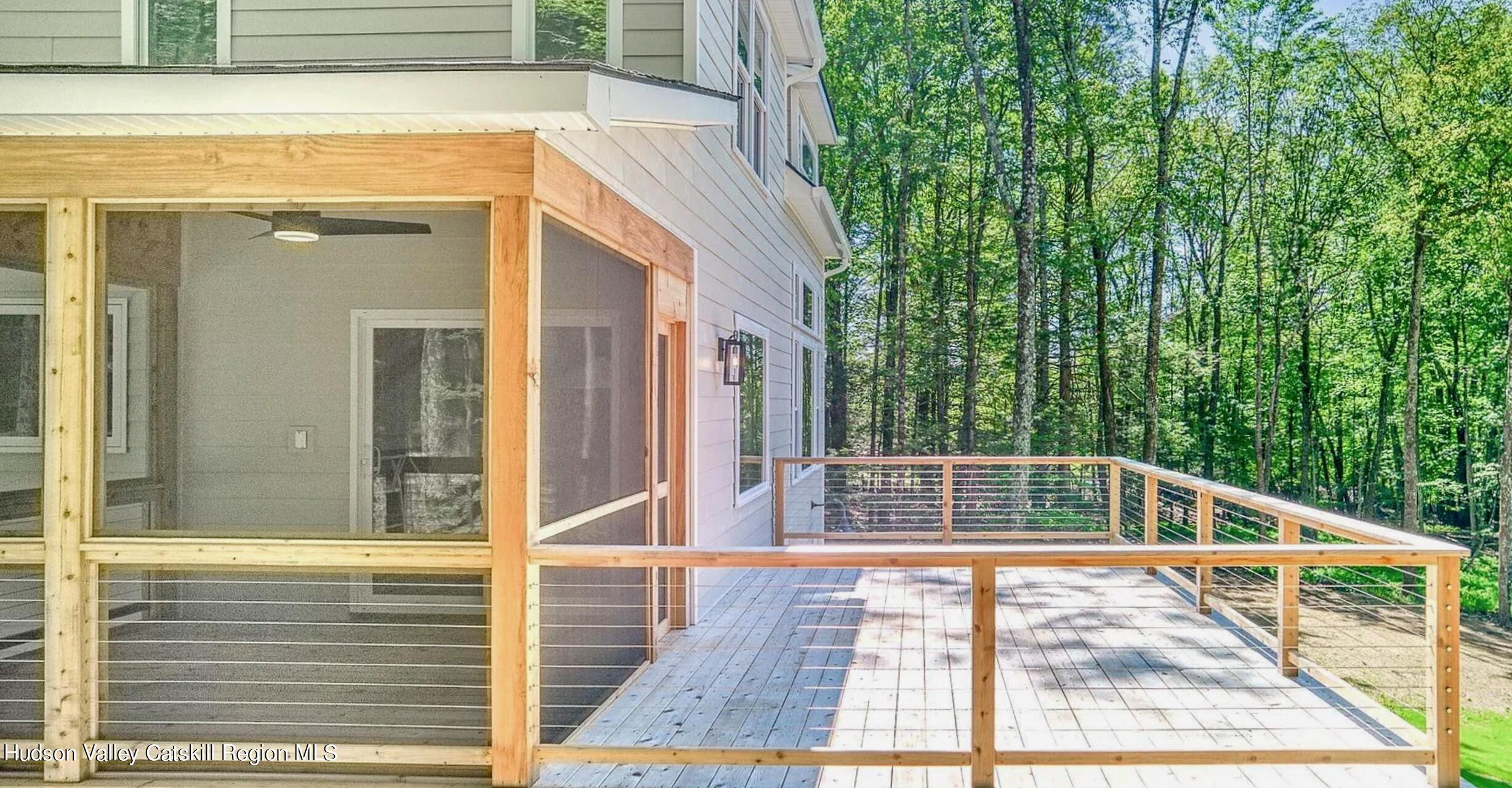382 Beaverkill Road Olivebridge, NY 12461 - Photo 34 of 40 a view of balcony with floor to ceiling window and wooden floor